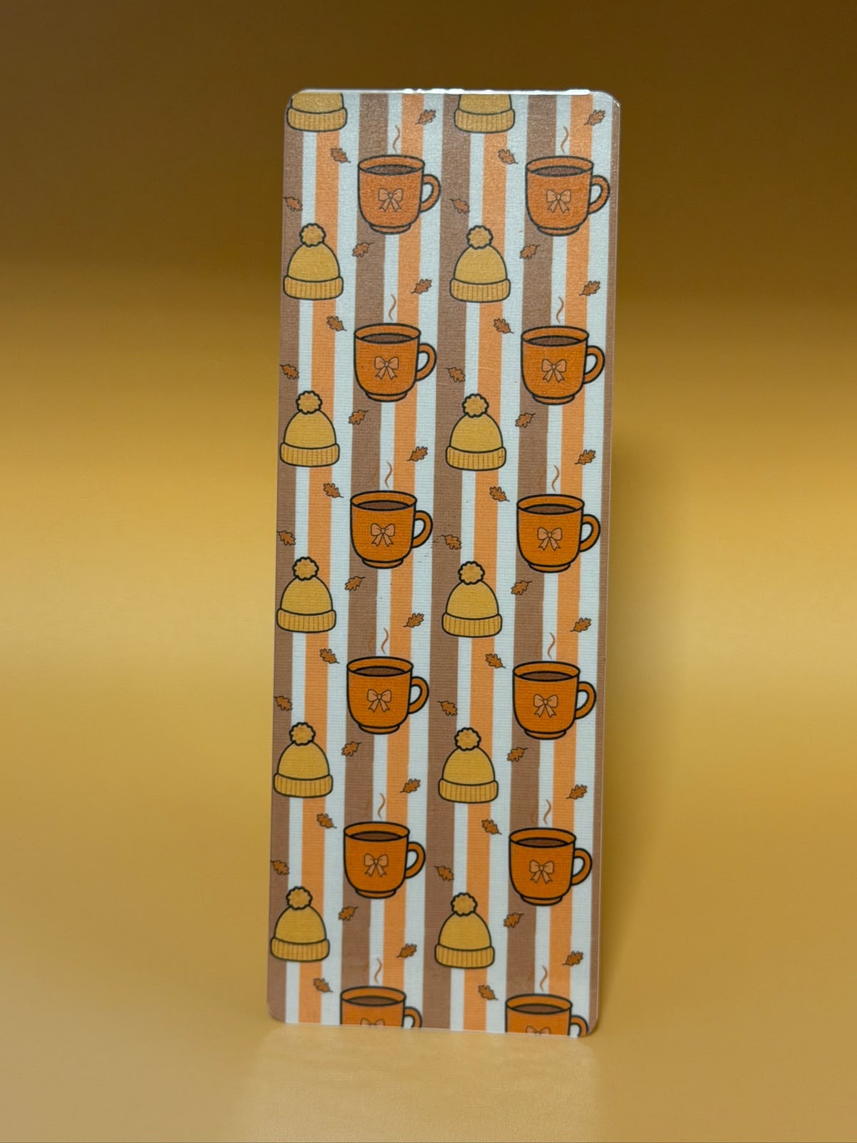 Cozy autumn bookmark with coffee mugs and beanies pattern